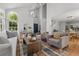 Bright living room with vaulted ceilings, oversized windows, hardwood floors, and stylish furnishings at 1359 S Beeler Ct, Denver, CO 80247