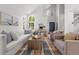 Inviting living room with high ceilings, large windows, hardwood floors, and comfortable seating at 1359 S Beeler Ct, Denver, CO 80247