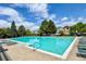 A sparkling pool, surrounded by lounge chairs, nestled within a charming residential community at 1359 S Beeler Ct, Denver, CO 80247
