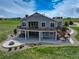 Backyard features a walkout deck and patio, a hot tub, and a fire pit with a seating area at 2504 Elkhorn Ranch St, Parker, CO 80138