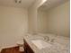Bathroom features granite counters with a white sink, complemented by wood-look flooring at 2504 Elkhorn Ranch St, Parker, CO 80138