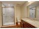 Updated bathroom features granite counters, wood-look flooring, and shower with marble tile surround at 2504 Elkhorn Ranch St, Parker, CO 80138