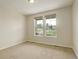 Bright bedroom with large windows and neutral carpeting at 2504 Elkhorn Ranch St, Parker, CO 80138