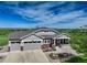 Charming home with a three-car garage and beautiful landscaping under a sunny blue sky at 2504 Elkhorn Ranch St, Parker, CO 80138