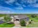Beautifully landscaped home with a three-car garage surrounded by a green lawn under a bright blue sky at 2504 Elkhorn Ranch St, Parker, CO 80138
