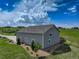 This detached three bay garage features plenty of additional parking and a well-kept lawn at 2504 Elkhorn Ranch St, Parker, CO 80138
