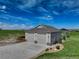 The large detached garage features three bays, plenty of parking, and a well-manicured lawn at 2504 Elkhorn Ranch St, Parker, CO 80138
