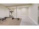 Unfinished basement with concrete floor section and a carpeted section featuring workout equipment at 2504 Elkhorn Ranch St, Parker, CO 80138