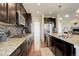 Modern kitchen with stainless steel appliances, granite countertops, and dark wood cabinetry at 2504 Elkhorn Ranch St, Parker, CO 80138