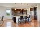 Gourmet kitchen featuring dark wood cabinets, stainless steel appliances, and island with seating at 2504 Elkhorn Ranch St, Parker, CO 80138