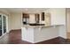 Kitchen area features granite counters, stainless appliances, and arched entryway at 2504 Elkhorn Ranch St, Parker, CO 80138