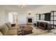 Open living room with a fireplace, sofa, and large TV, perfect for relaxing at 2504 Elkhorn Ranch St, Parker, CO 80138