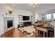 Cozy living room with a fireplace, hardwood floors, and stylish furniture at 2504 Elkhorn Ranch St, Parker, CO 80138