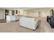 Bright open living room with plush carpet, a bar counter, and views into the kitchen at 2504 Elkhorn Ranch St, Parker, CO 80138