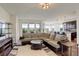 Spacious living room with sofa, open layout, hardwood floors, and abundant natural light at 2504 Elkhorn Ranch St, Parker, CO 80138