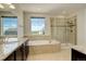Bright main bathroom with soaking tub, shower, double vanity sinks and private toilet at 2504 Elkhorn Ranch St, Parker, CO 80138