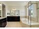 Bright main bathroom with soaking tub, shower, double vanity sinks and tiled floors at 2504 Elkhorn Ranch St, Parker, CO 80138