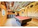 The large rec room features tongue and groove walls, a full bar, and plenty of games for your entertainment at 2504 Elkhorn Ranch St, Parker, CO 80138