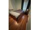 Comfortable bedroom featuring a bed with wooden drawers, a striped blanket, and hardwood floors at 1082 Geneva St, Aurora, CO 80010