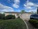 Cozy one-story home with a well-maintained lawn and mature landscaping, complemented by a clear sky backdrop at 1082 Geneva St, Aurora, CO 80010