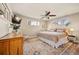 Cozy bedroom with a ceiling fan, dresser, and a TV for relaxation at 871 Quebec St, Denver, CO 80220