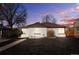 Charming single-story home with a white brick facade and well-maintained front yard at 871 Quebec St, Denver, CO 80220