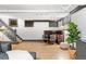 Basement with stairs, a table and chairs, a light colored floor, and a gray sofa at 1500 E 7Th Ave, Denver, CO 80218