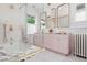 Bathroom featuring a marble tub, a double sink vanity, and decorative gold mirrors at 1500 E 7Th Ave, Denver, CO 80218
