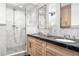 Bathroom with a double sink vanity with wood drawers, marble countertop, and a glass-enclosed shower at 1500 E 7Th Ave, Denver, CO 80218