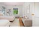 Bedroom featuring two beds, a white couch, and gray window shades at 1500 E 7Th Ave, Denver, CO 80218