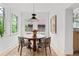 Bright dining area with a round table, patterned chairs, and natural light from windows at 1500 E 7Th Ave, Denver, CO 80218