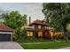 Beautiful home exterior with lush landscaping, a garage, and a well-maintained lawn at 1500 E 7Th Ave, Denver, CO 80218