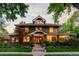 Charming two-story home with brick exterior, landscaped yard, and inviting front porch at 1500 E 7Th Ave, Denver, CO 80218