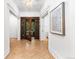 Elegant foyer featuring hardwood floors, white walls, decorative molding and a striking glass paneled front door at 1500 E 7Th Ave, Denver, CO 80218