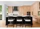 Stylish kitchen with island, marble countertops, designer backsplash, and modern appliances at 1500 E 7Th Ave, Denver, CO 80218