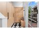 Well-organized mudroom with built-in storage, bench, and black and white tile flooring at 1500 E 7Th Ave, Denver, CO 80218