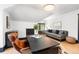Comfortable home office with a modern black desk, gray sofa, overhead lighting, and hardwood floors at 1500 E 7Th Ave, Denver, CO 80218