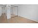 Minimalist bedroom featuring hardwood floors, natural light and a large closet at 2461 Yates St, Denver, CO 80212