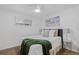 Cozy bedroom featuring a ceiling fan, a large window, and comfortable furnishings at 2461 Yates St, Denver, CO 80212
