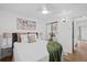 Comfortable bedroom features a ceiling fan, a large window, mirrored closet doors, and warm lighting at 2461 Yates St, Denver, CO 80212