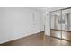 Bright bedroom featuring wood floors, large sliding mirrored closet, and neutral wall paint at 2461 Yates St, Denver, CO 80212