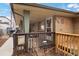Cozy front porch with brick detail and security system, perfect for relaxing outdoors at 2461 Yates St, Denver, CO 80212