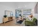 Bright living room featuring hardwood floors, a decorative rug, and a cozy seating area at 2461 Yates St, Denver, CO 80212