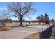 Scenic street view near calm lake features lush green spaces and a clear blue sky at 2461 Yates St, Denver, CO 80212