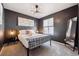 Modern bedroom with gray walls, stylish lighting, an accent mirror, and a plush plaid blanket at 8863 Osceola St, Westminster, CO 80031