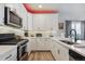 Well-appointed kitchen with stainless steel appliances, white cabinetry, and modern fixtures, offering style and functionality at 8863 Osceola St, Westminster, CO 80031