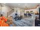 Spacious living area flowing into the kitchen, featuring hardwood floors and a comfortable seating arrangement at 8863 Osceola St, Westminster, CO 80031