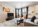 Bright living room with a corner window, modern decor, and a cozy seating area at 8863 Osceola St, Westminster, CO 80031