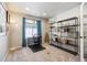 The home office features a sleek desk, comfortable chair, shelving unit, and natural light at 8863 Osceola St, Westminster, CO 80031