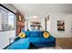 Cozy living space featuring brick accent wall, balcony access, and comfortable seating at 1898 S Bannock St # 202, Denver, CO 80223